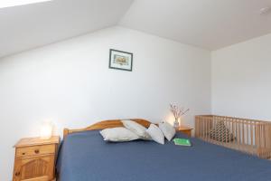 a bedroom with a bed with blue sheets and pillows at LM3-33 - Ferienwohnung Typ AB Komfort - a98967 in Schottwarden