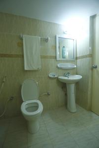 a bathroom with a toilet and a sink at Hotel Garden Inn in Sylhet