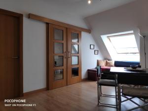 a living room with a skylight and a room with a table at La Mariña in Ribadeo