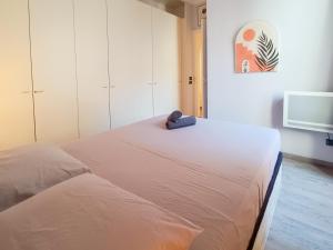 a bedroom with a bed with a towel on it at France 66 4 Pers AC WiFi in Nice
