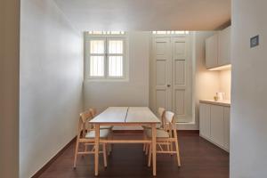 a dining room with a table and chairs at KINN Studios in Singapore