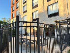 a black fence with chairs and tables in front of a building at Holiday Inn Express & Suites - Prospect Heights, an IHG Hotel in Prospect Heights