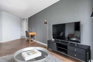 a living room with a large flat screen tv at Central Square 2br w in-unit wd nr restaurants BOS-898 in Cambridge