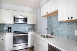 a white kitchen with a sink and a microwave at Central Square 2br w in-unit wd nr restaurants BOS-898 in Cambridge