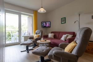 a living room with a couch and chairs and a table at LM5-11 - Ferienwohnung Typ B Komfort in Schottwarden
