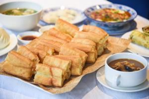 a table with a plate of sandwiches and a cup of soup at Hilton Zhengzhou in Zhengzhou