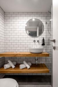 a bathroom with a sink and a mirror at Prima City Hotel in Tel Aviv