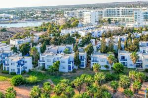 an aerial view of a city with white houses and palm trees at Atlantica Callisto in Ayia Napa