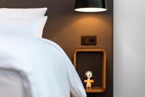 a bedroom with a bed with a mirror and a stuffed animal at The Barthels Boutique Hotel in Würzburg