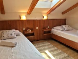 a bedroom with two beds and two lights on the wall at Apartment Anima 3 in Klimno