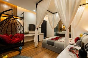 a bedroom with a bed and a hanging swing at MICASA HOTEL in Ho Chi Minh City