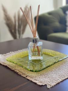 a bottle of perfume sitting on a table at Villa Rada, Bay View Villas in Kosharitsa