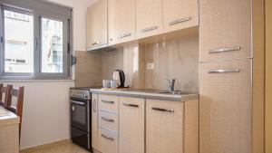 a kitchen with a sink and a stove at Stylish Extra - BIG 1+1 Central Apt in Himare