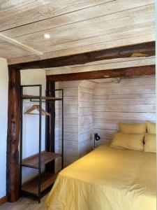 a bedroom with a bed with a wooden ceiling at Domaine des Combes - La Ferme aux Anes 14 pers. in Millau +20 photos