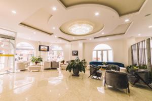 a lobby of a building with couches and chairs at Dalat Paradise Hotel in Da Lat