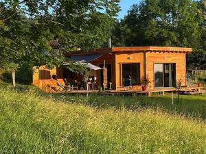 a small house in a field of grass at La Petite Maison du hÊtre in Brassac