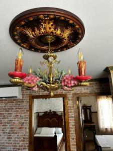 a chandelier and a mirror in a room at Luxury art Apartamenty in Pineda de Mar