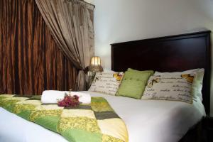 a bedroom with a bed with a flower arrangement on it at Zoete Rust Boutique Hotel in Lephalale