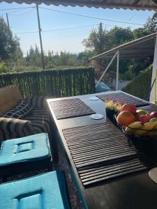 a picnic table with a basket of fruit on it at Villa Julia in Nea Michaniona