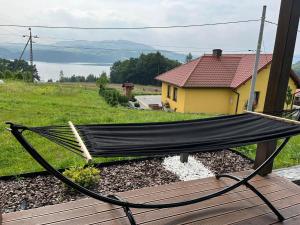 a hammock sitting on top of a house at Wichrowe Wzgórze z jacuzzi in Znamirowice