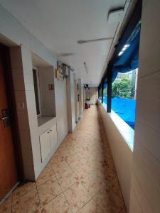 an empty hallway of a hospital with a view of a pool at Capital Hotel in Mumbai