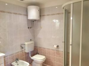 a bathroom with a toilet and a sink and a shower at Apartment Anima 3 in Klimno +20 photos