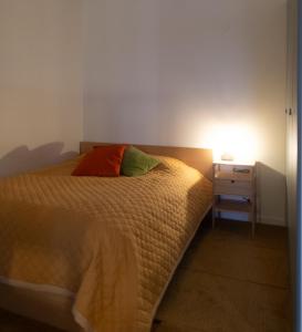 a bedroom with a bed and a night stand with a lamp at The Studio in Skellefteå