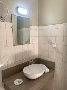 a bathroom with a bowl sink and a mirror at Hotel Ideal in Chapecó +85 photos