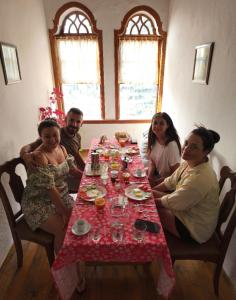 eine Gruppe von Menschen, die um einen Tisch sitzen in der Unterkunft Guest House Panorama in Berat