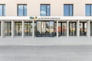 a building with the entrance to the mxx laboratories headquarters at Maxx Hotel Aalen in Aalen