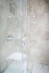 a bathroom with a shower with a glass door at Luxury Loft Flat 5 mins away by the Sea /Nr:2 in Istanbul