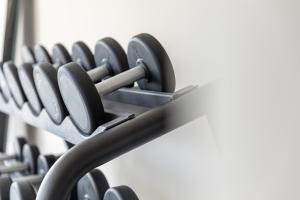 a row of black dumbbells in a gym at Maxx Hotel Aalen in Aalen