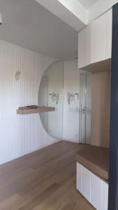 eine Küche mit weißen Wänden, weißen Schränken und Holzböden in der Unterkunft Appart 7P vue Seine, Tour Eiffel in Issy-les-Moulineaux
