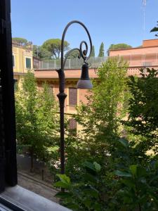 a street light in front of some trees at Quiet in Biancamano - Casa Vacanze Roma in Rome