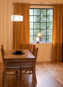 a dining room table with two chairs and a window at The Studio in Skellefteå