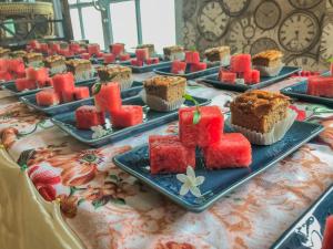 un tavolo con piatti di torte e cupcake di ณ บ้านแม่ รีสอร์ท a Ban Rai