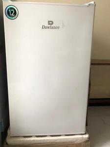 a white refrigerator with a sign on the side of it at Murree Oaks Tulip Block in Murree +17 photos