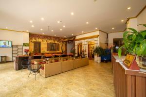 a large room with a lobby with a lot of plants at Grand Flamant Hotel Sapa in Sa Pa
