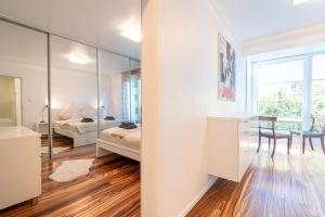 a bedroom with a bed and a desk and a mirror at Luxus Apartment in bester Lage in Bremen