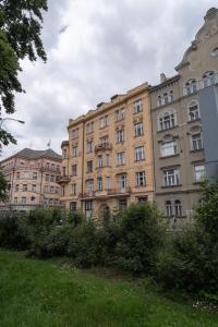 a large building in the middle of a field at Attic Apartment in Smíchov by Prague Days in Prague