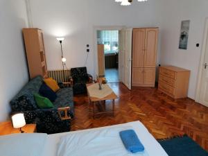 a living room with a couch and a table at Hanna 3 Apartman in Kőszeg