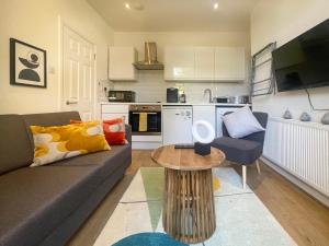 a living room with a couch and a table at Sweet&Stylish 1 bed flat in CamdenTown in London