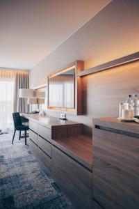 a kitchen with a sink and a desk with a mirror at Hotel Wellness Medical Spa Unitral in Mielno