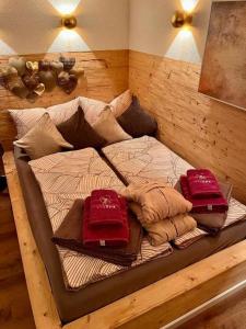 a bed in a room with two pillows on it at Chalet VitaSpa - Whirlpool & Sauna PrivatSpa in Pegnitz