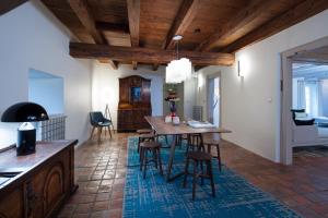 a kitchen and living room with a wooden table and chairs at Domaine du Kaegy - Hébergements 5 étoiles in Steinbrunn-le-Bas