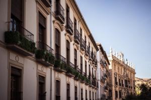 a building with balconies and plants on the side of it at HERMOSA 7 in Granada