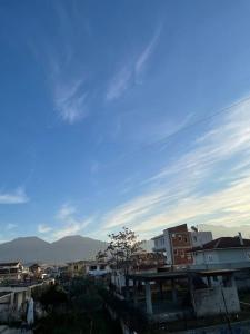 a view of a city with buildings and mountains at Comfortable and Luxurious home in Kamëz