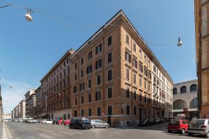 a large brick building on a city street at Termini & Acquario Romano Bright Apartment in Rome