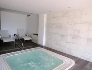 a hot tub in a room with white walls at BG Nautico Ebeso in Ibiza Town