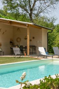 a house with a swimming pool in the yard at Le Moulin de la Maison des Templiers in Saint-Cernin-de-Larche